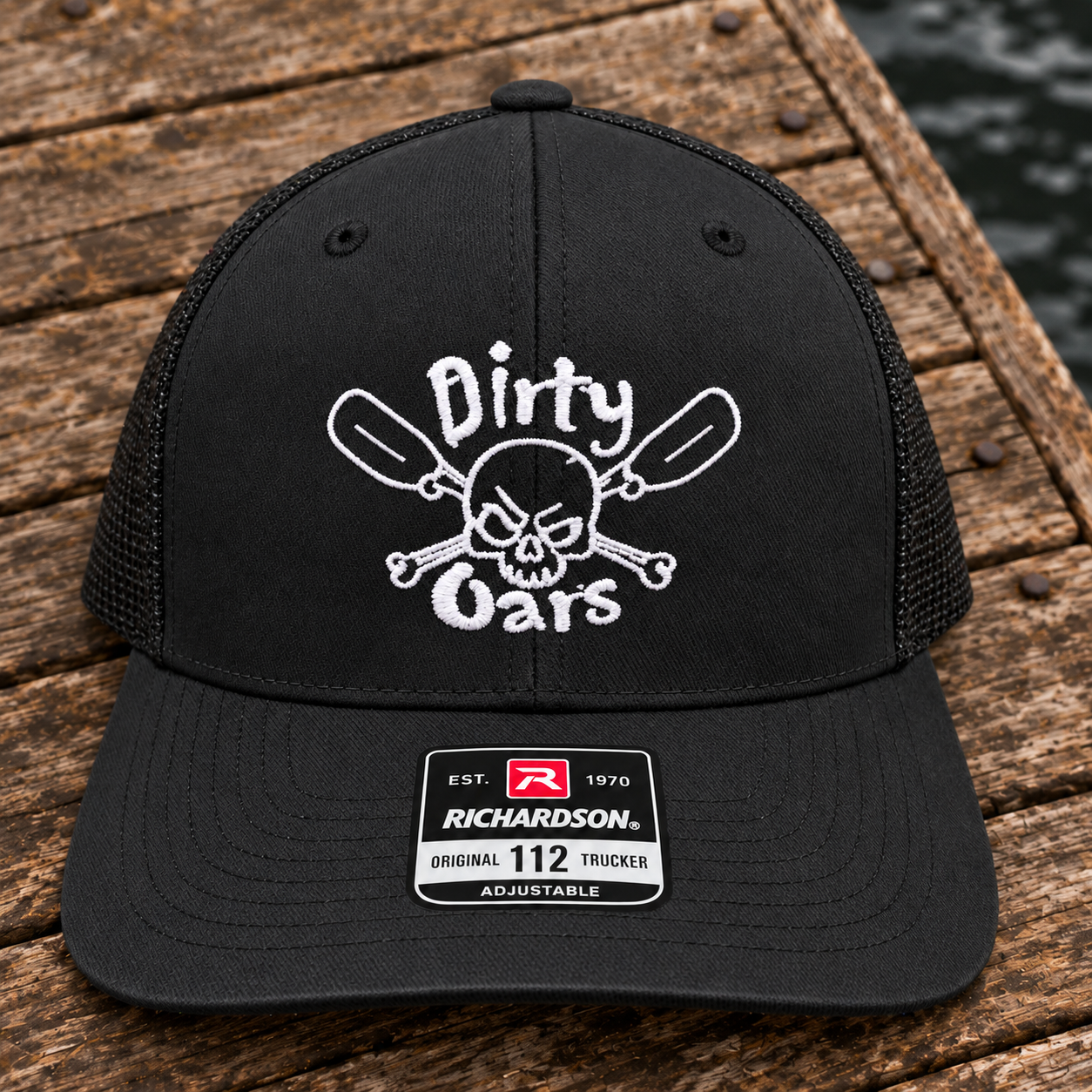 Black Richardson 112 trucker cap embroidered with the white Dirty Oars logo